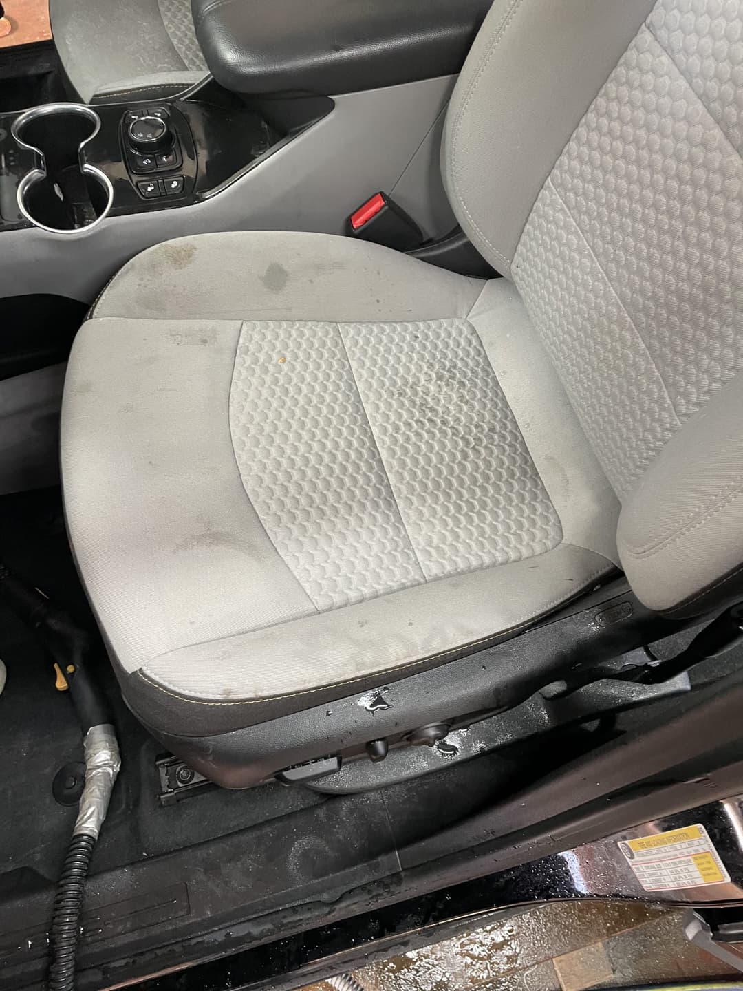 Cloth car seat before stain removal and interior detailing